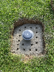 Installation au sol avec du béton de la base d'ancrage pour parasol